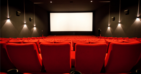 Interior shot of a large, empty movie theatre. Image credit: m4tik via Flickr